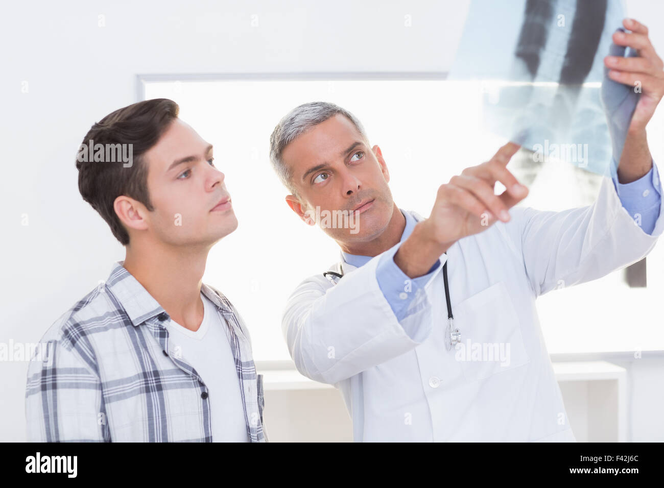Doctor showing X rays to his patient Stock Photo Alamy