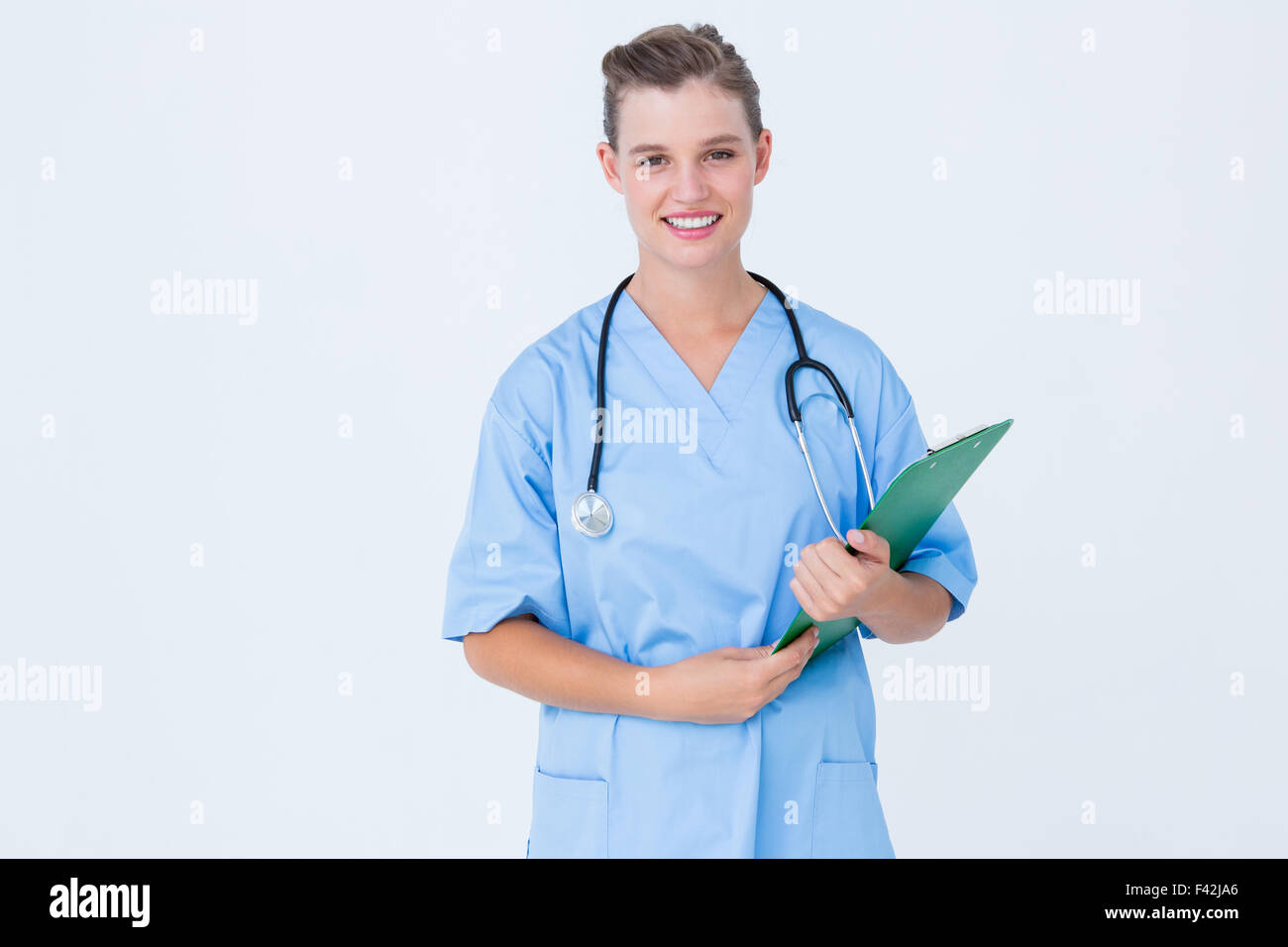 Smiling nurse holding clipboard Stock Photo - Alamy
