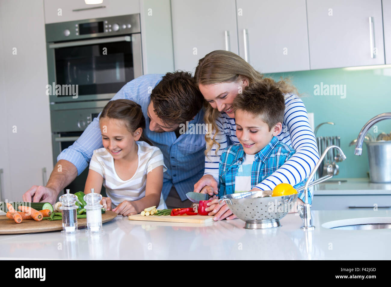 Happy family preparing vegetables together Stock Photo