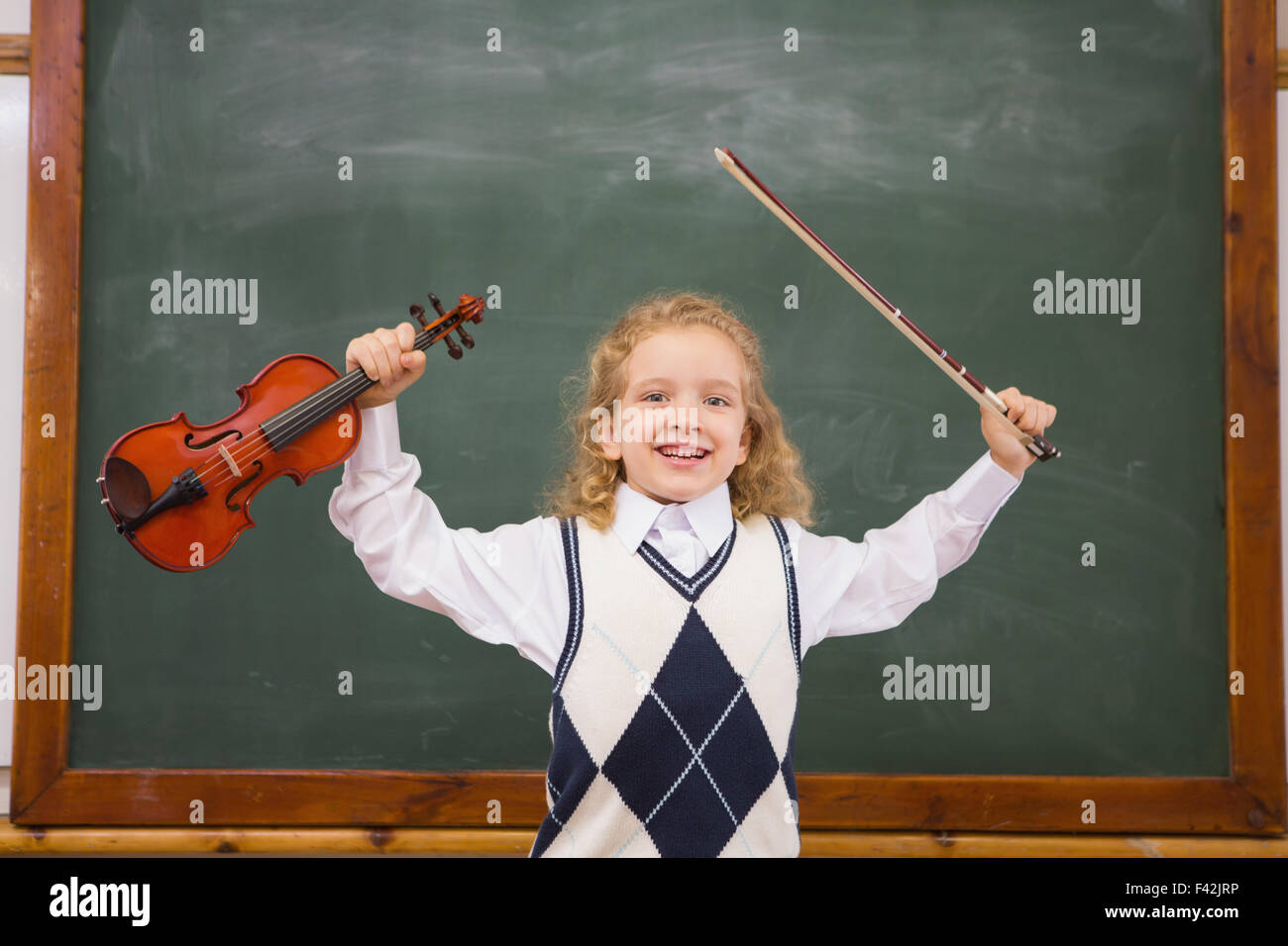 Cute pupil holding violin and violin string Stock Photo - Alamy