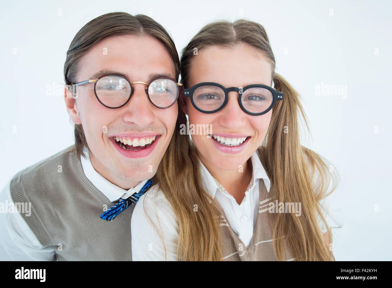 Geeky hipsters smiling at camera Stock Photo