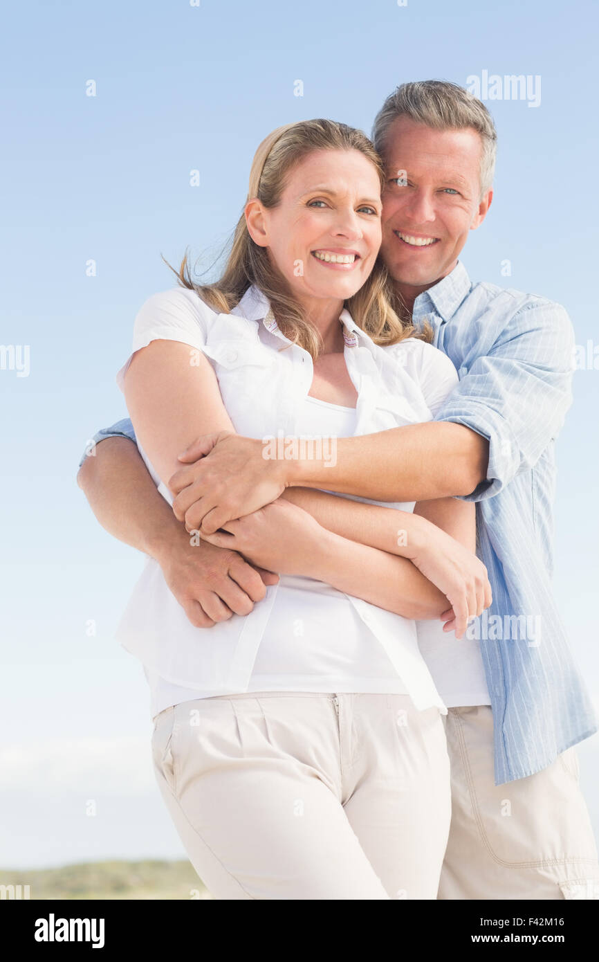 Happy couple smiling at camera Stock Photo - Alamy