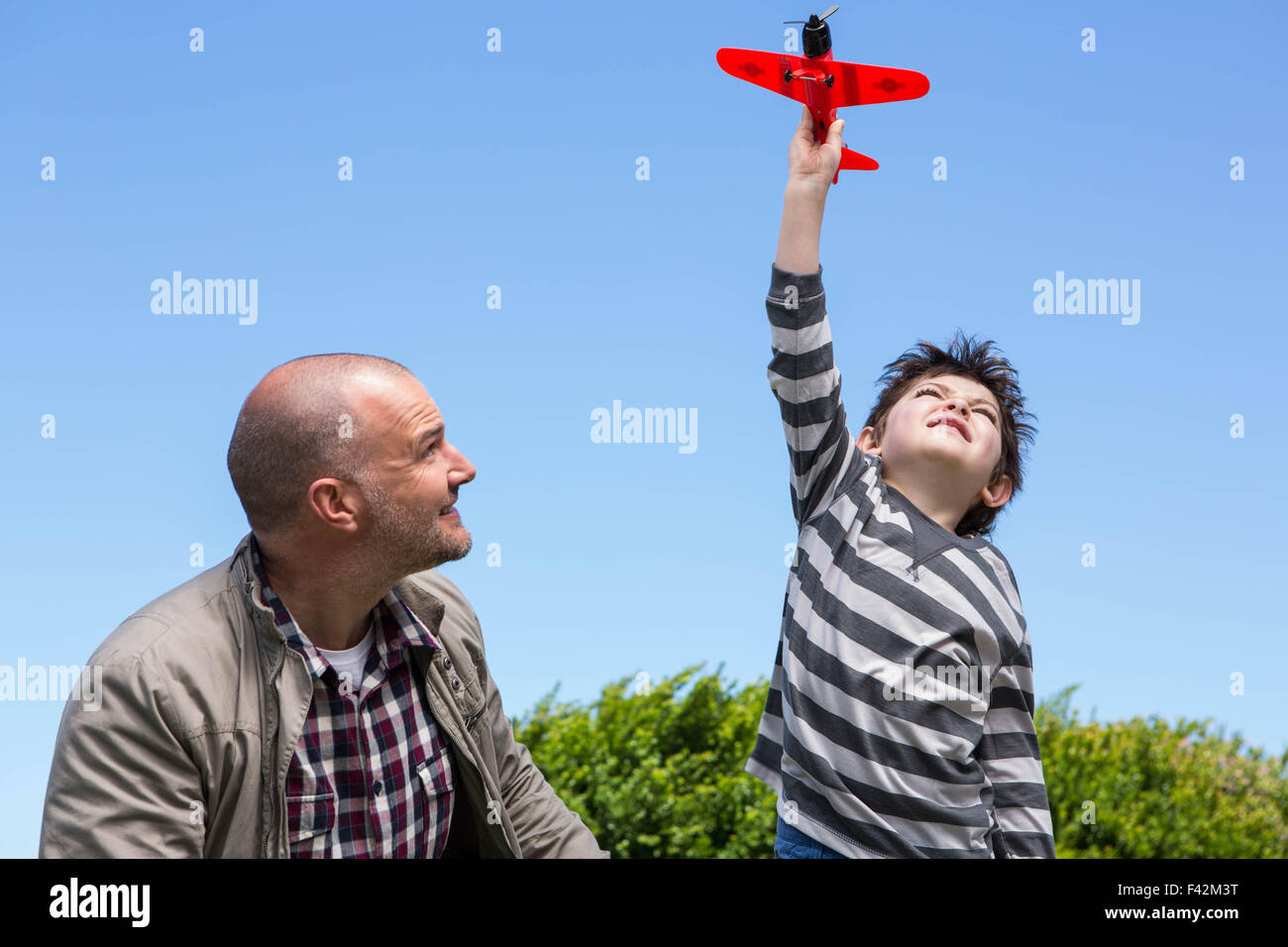 Young boy playing with a toy plane Stock Photo