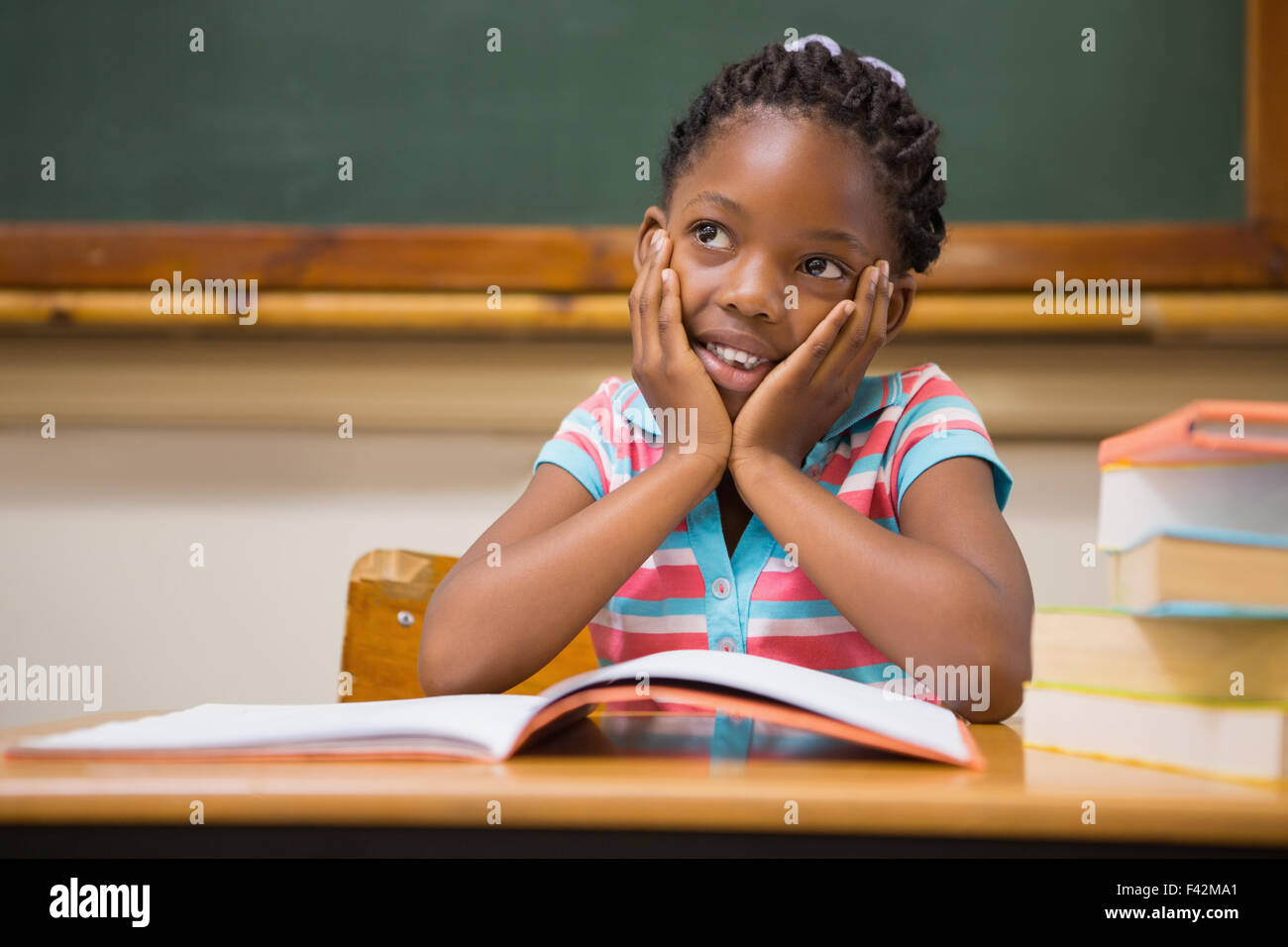 Pupil sitting at her desk Stock Photo - Alamy