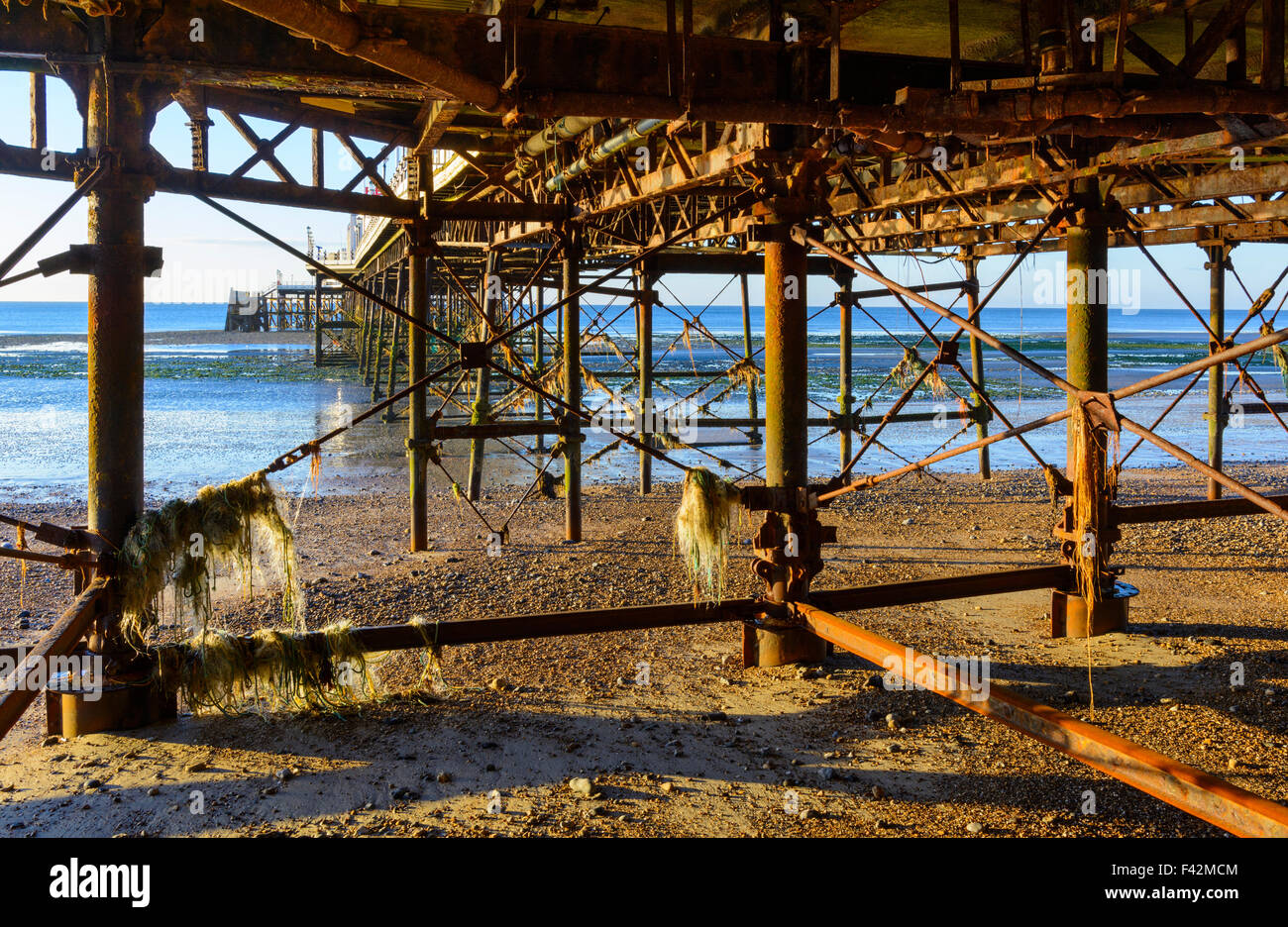 Underside of a weathered decaying pier in the UK. Stock Photo