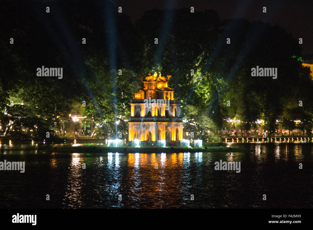 Hoan Kiem Lake in Hanoi is a focus for the capital city of Vietnam. Turtle Tower (Thap Rùa) is illuminated Stock Photo