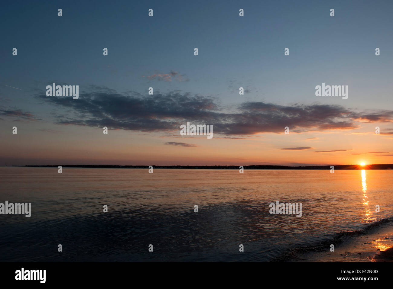 Tranquil beach sunset Stock Photo