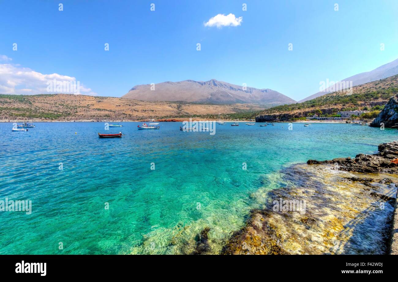 The beautiful Greek coastline with crystal clear waters and many boats anchored near Diros caves in Greece. A stunning scenery, Stock Photo