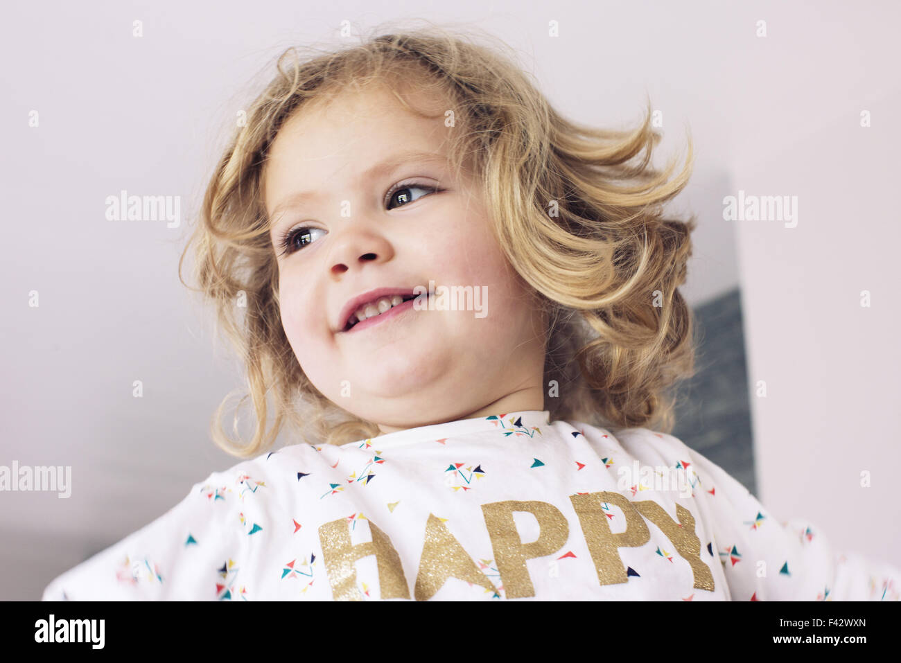 Little girl smiling, looking away, portrait Stock Photo