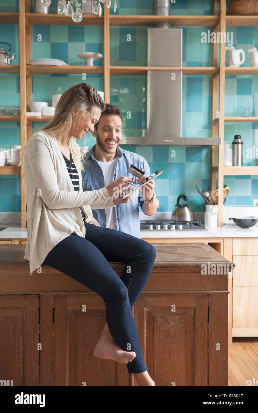 Couple shopping online at home Stock Photo