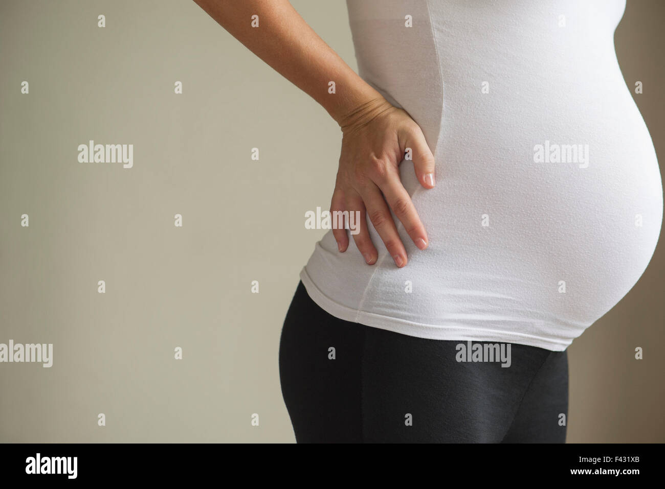 Pregnant woman massaging lower back Stock Photo Alamy