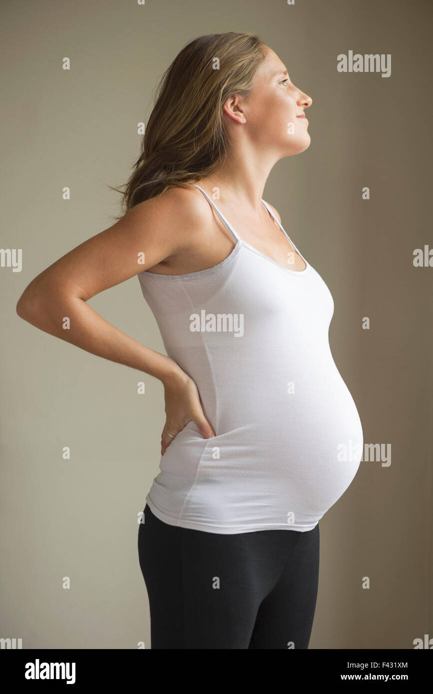 Pregnant woman massaging lower back Stock Photo Alamy
