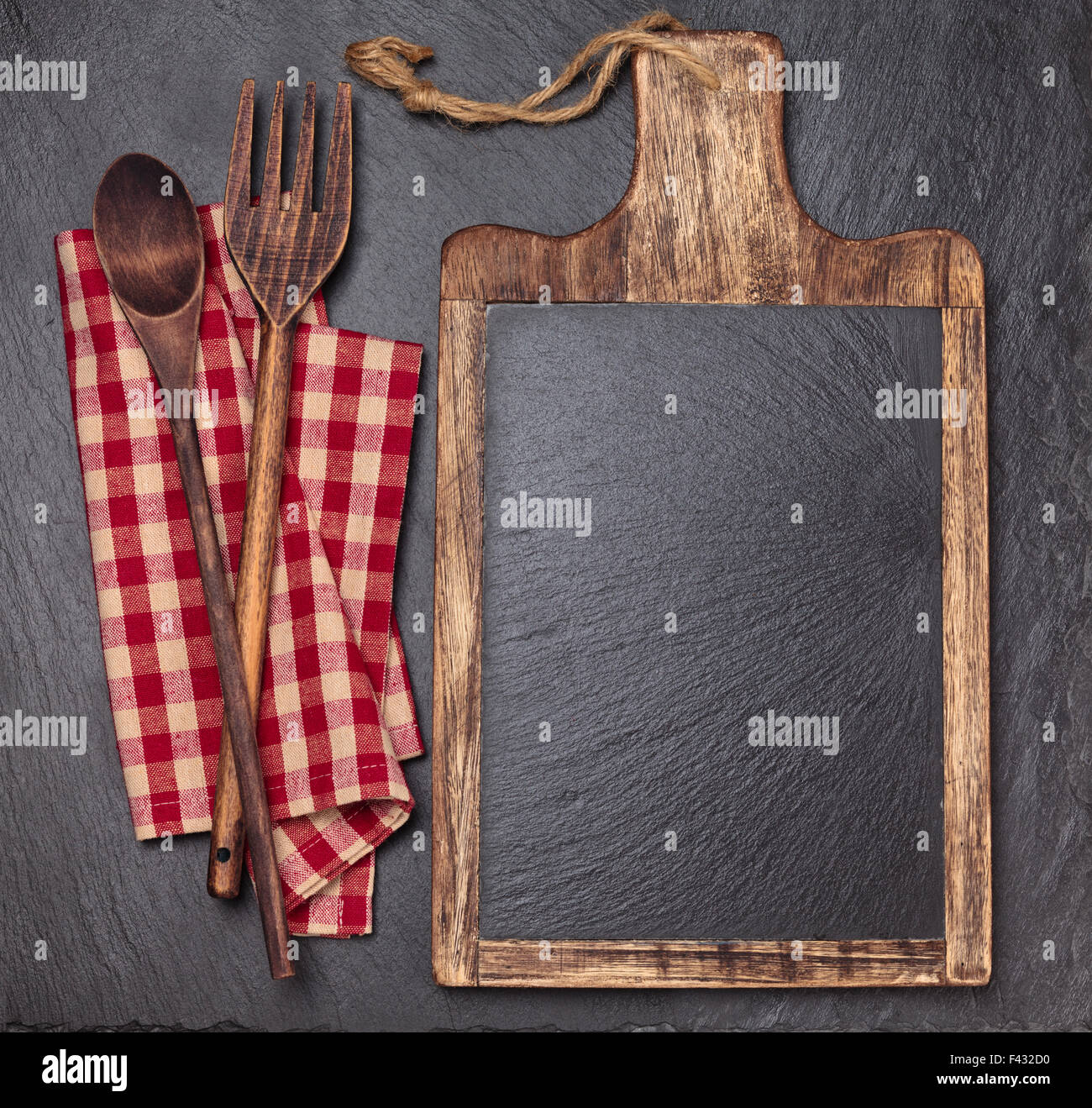 Cutting board, tablecloth, wooden spoons and piece of chalk. Stock Photo