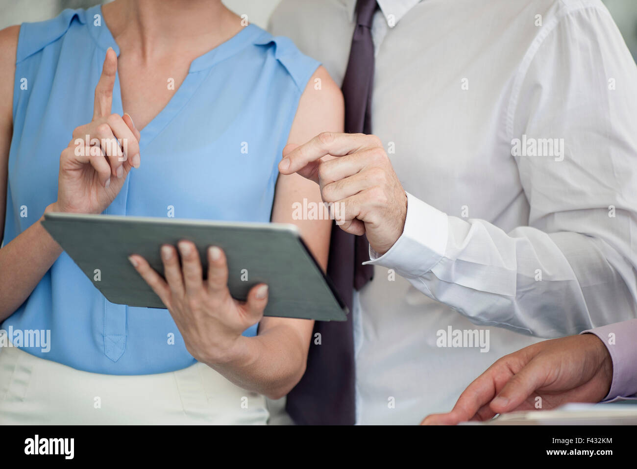 Business colleagues working together with digital tablet, cropped Stock Photo