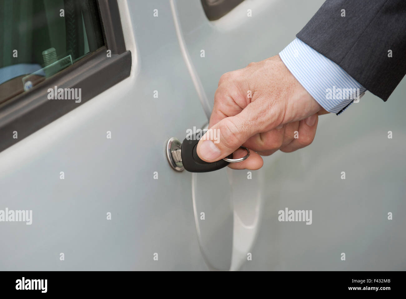 Man unlocking car door with key, cropped Stock Photo