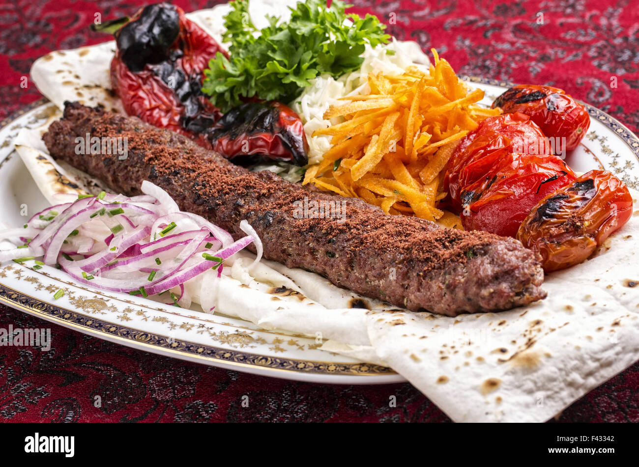 adana kebab with salad and flat bread Stock Photo