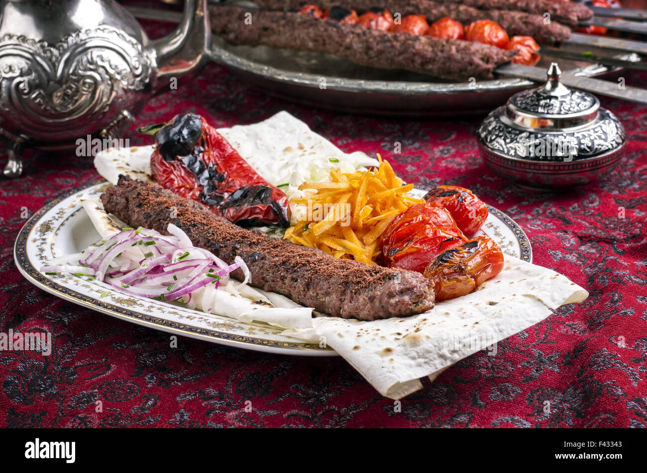 grilled adana kebab with vegetables Stock Photo