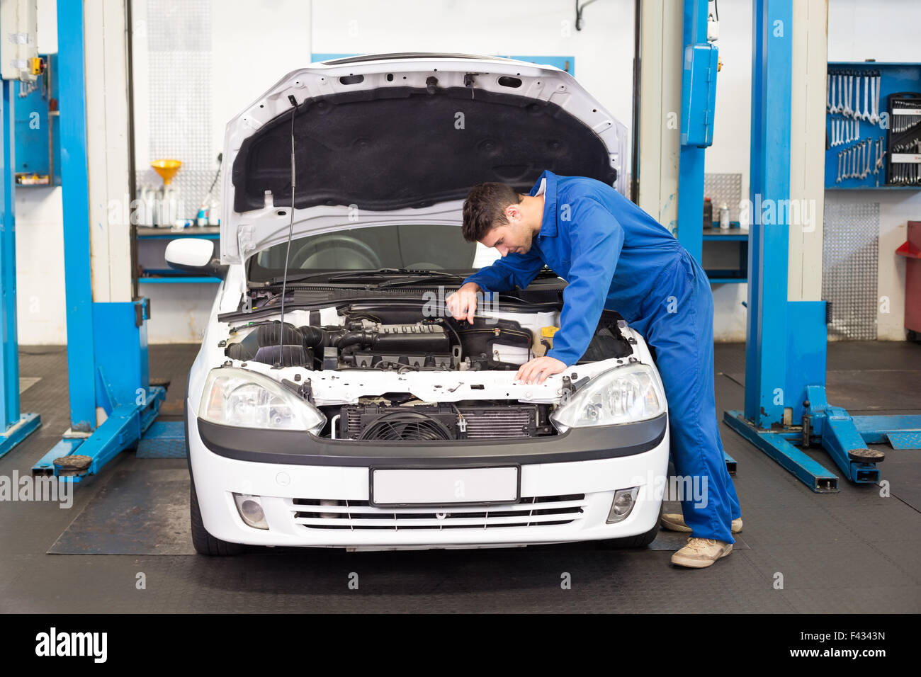 Mechanic Examining Under Hood Of Car Stock Photo - Alamy