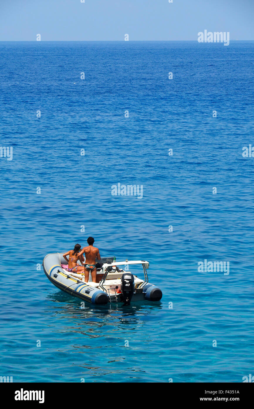 A couple on a rubber dinghy in the Tyrrhenian Sea off Scilla, Calabria. Stock Photo