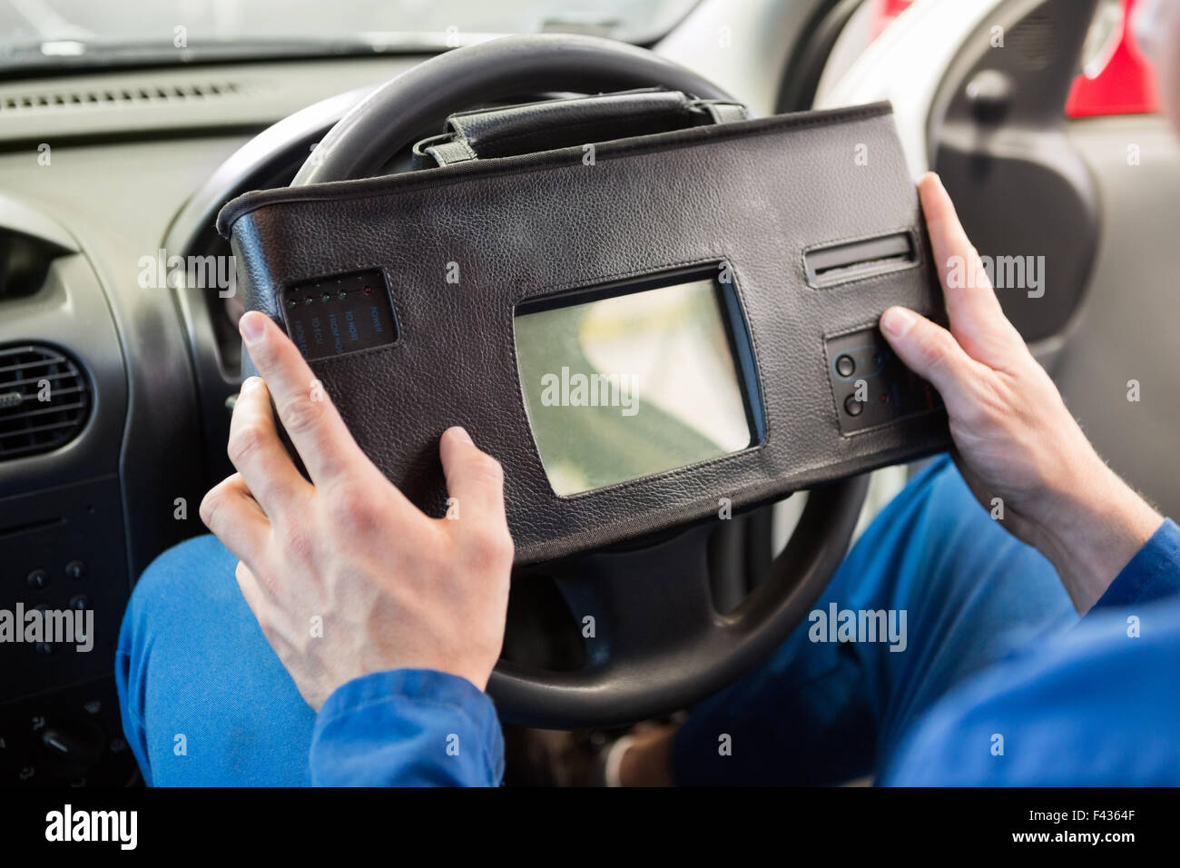 Mechanic using diagnostic tool in the car Stock Photo Alamy