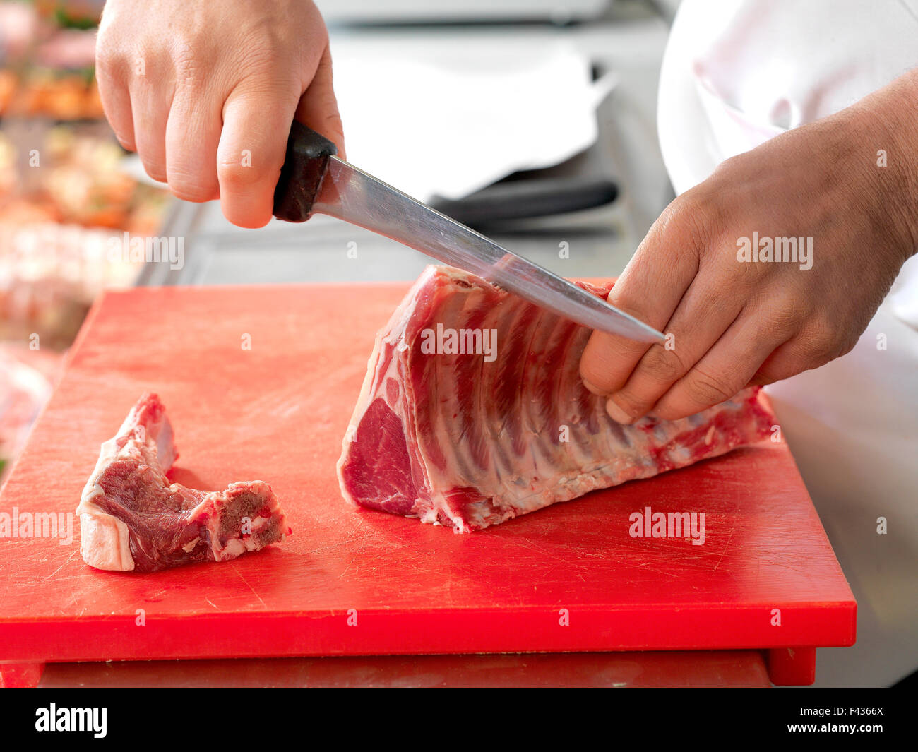 Butcher cutting meat Stock Photo