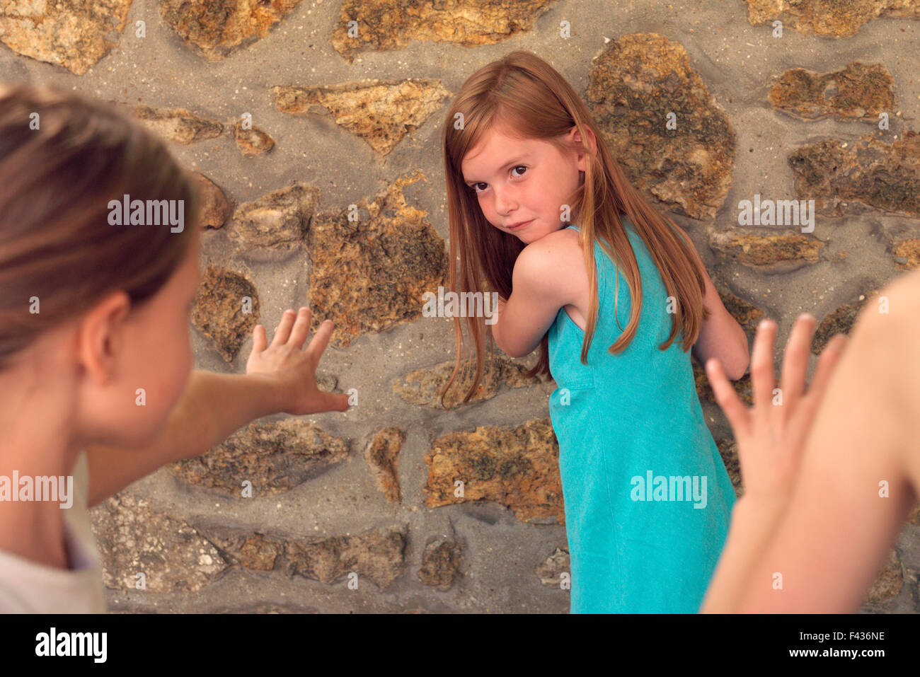 Girl playing tag with friends Stock Photo