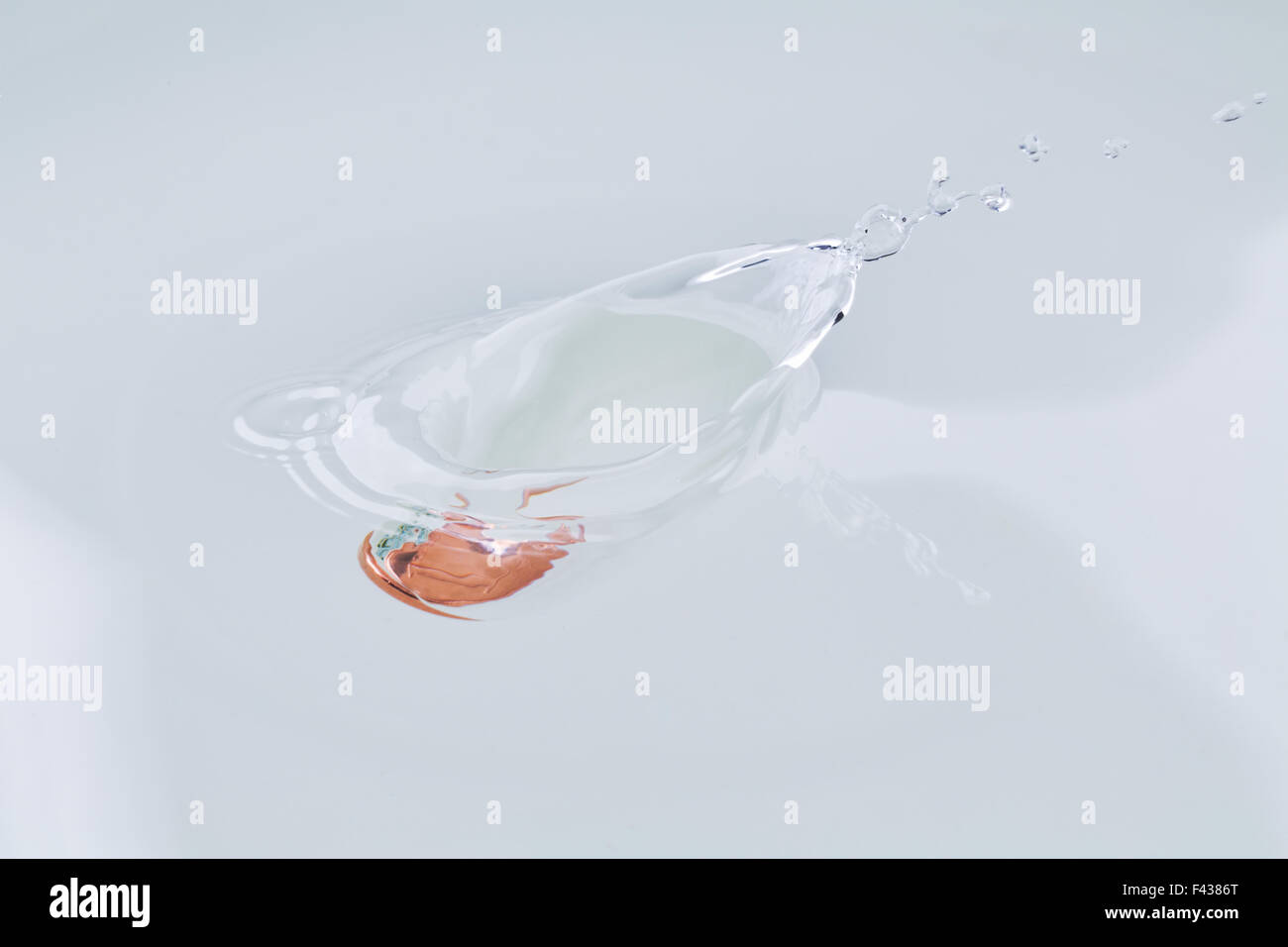 One euro cent splash water drowning. Stock Photo