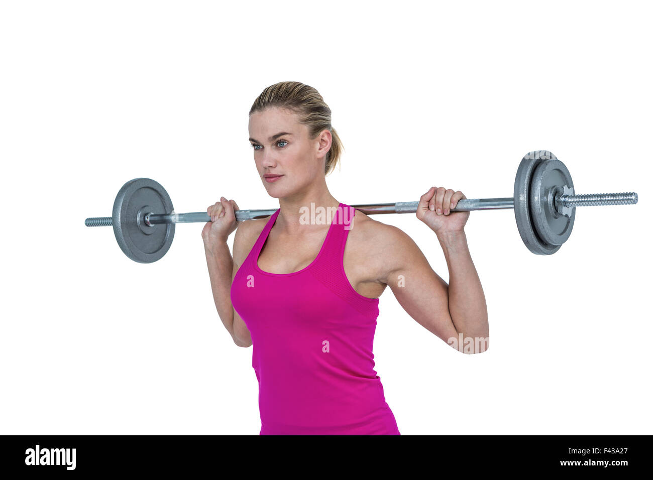 Sporty female bodybuilder lifting barebell Stock Photo