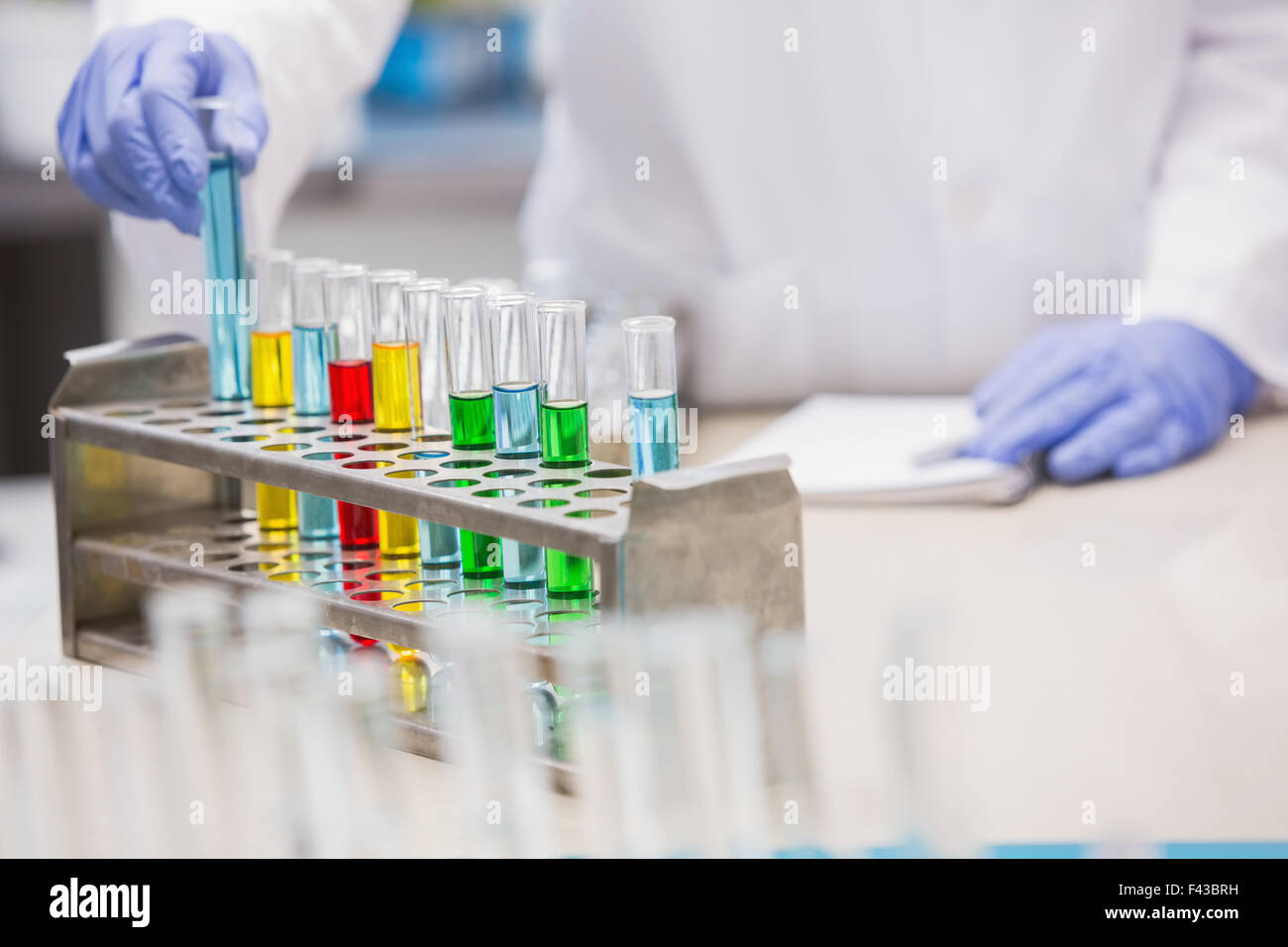 Scientist examining tubes Stock Photo