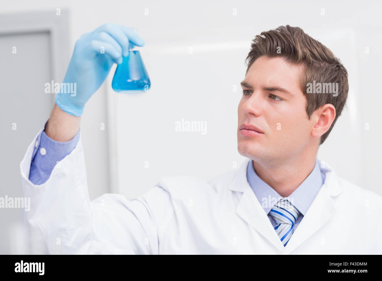 Scientist looking attentively at the beaker Stock Photo Alamy