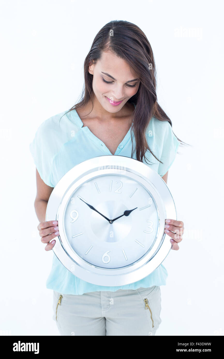 Beautiful woman holding a clock Stock Photo - Alamy