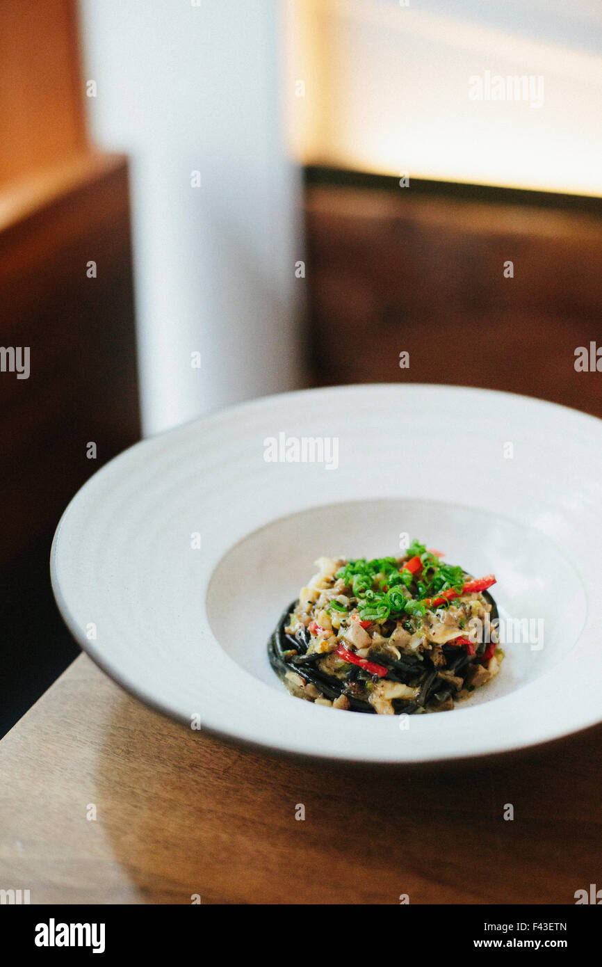 Close up of a plate of freshly prepared vegetables, an elegantly presented garnished dish at a city restaurant. Stock Photo