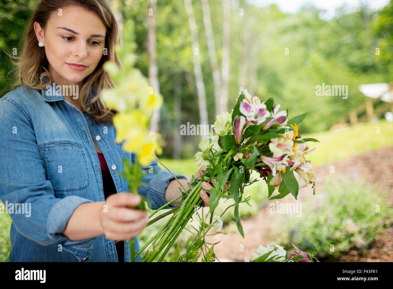 A woman holding a bunch of  summer garden flowers. Stock Photo