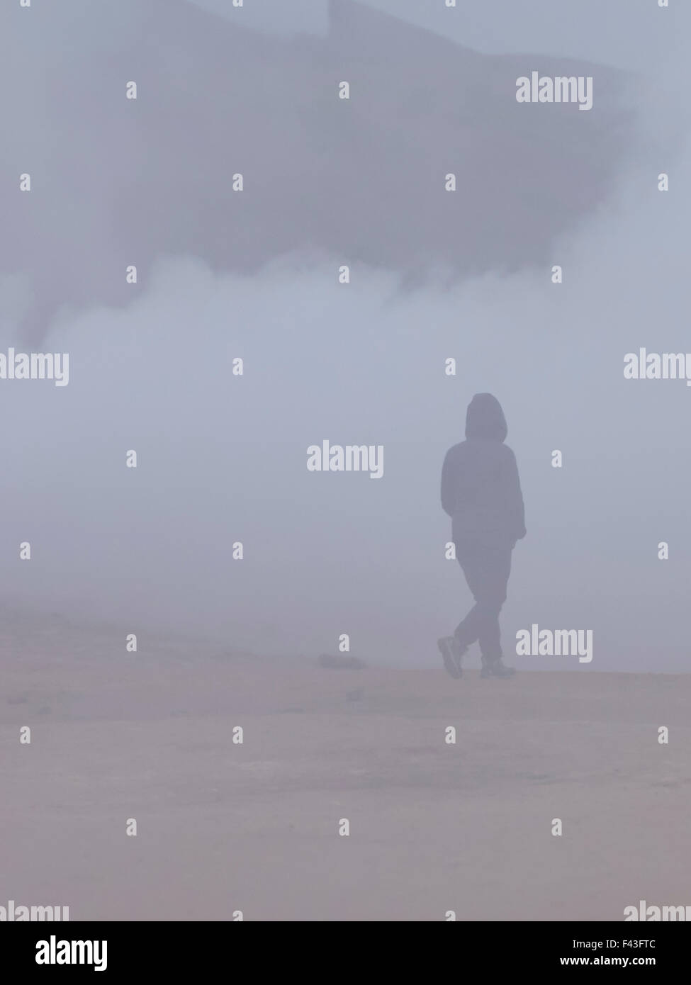 A person walking through vapour and steam from the hot springs in Iceland. Stock Photo