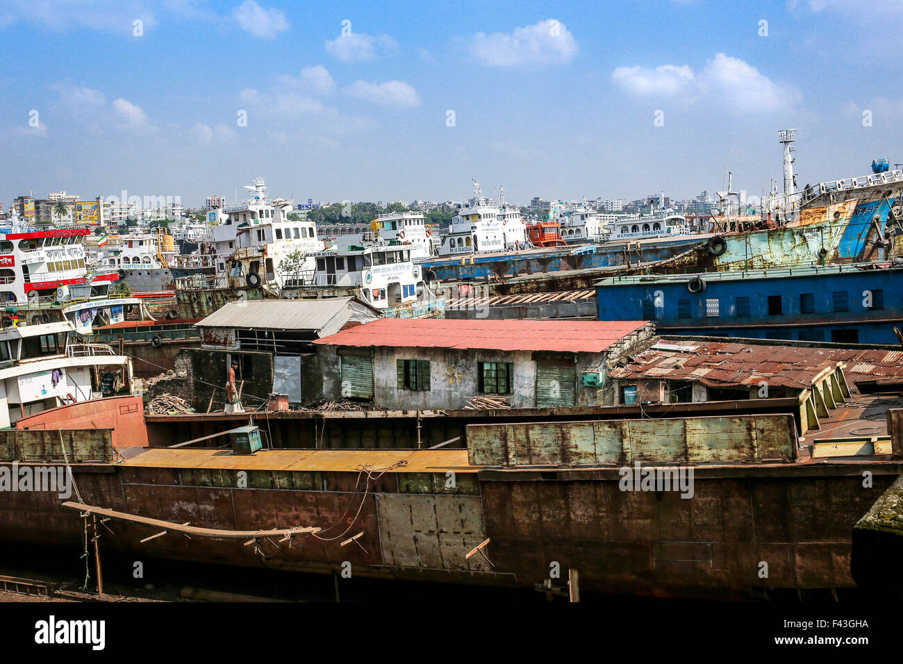 Dhaka, Bangladesh. 14th Oct, 2015. Oct 14, 2015 - Dhaka, Bangladesh - Ship building industry in Bangladesh spreading rapidly where workers from all ages work together. The working condition here is serious and not suitable for any children. Conditions are hot and often dangerous. Even workers don't use minimum safety guard. Therefore accidents happen very frequently. Children who work here are growing up without education which has been leading them towards uncertain future. The reason of child labor in such dangerous working condition is cheap labor and poverty. According to child labor law Stock Photo