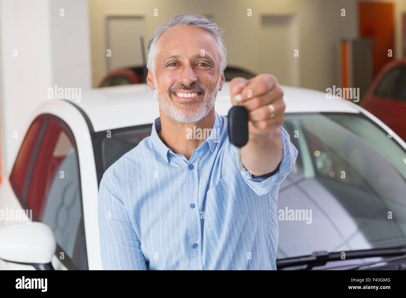 Smiling customer showing his new key Stock Photo - Alamy