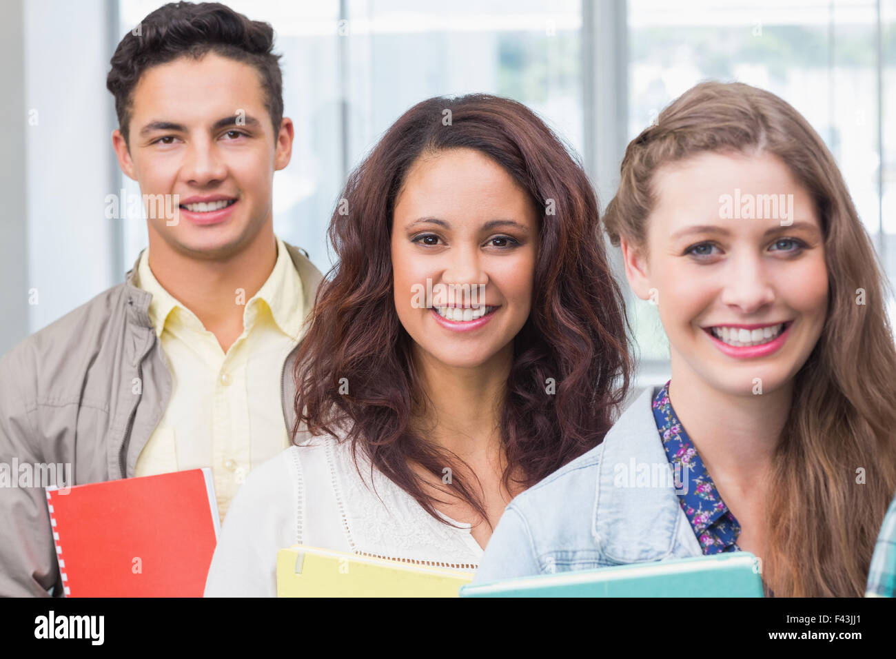 Fashion students smiling at camera together Stock Photo - Alamy