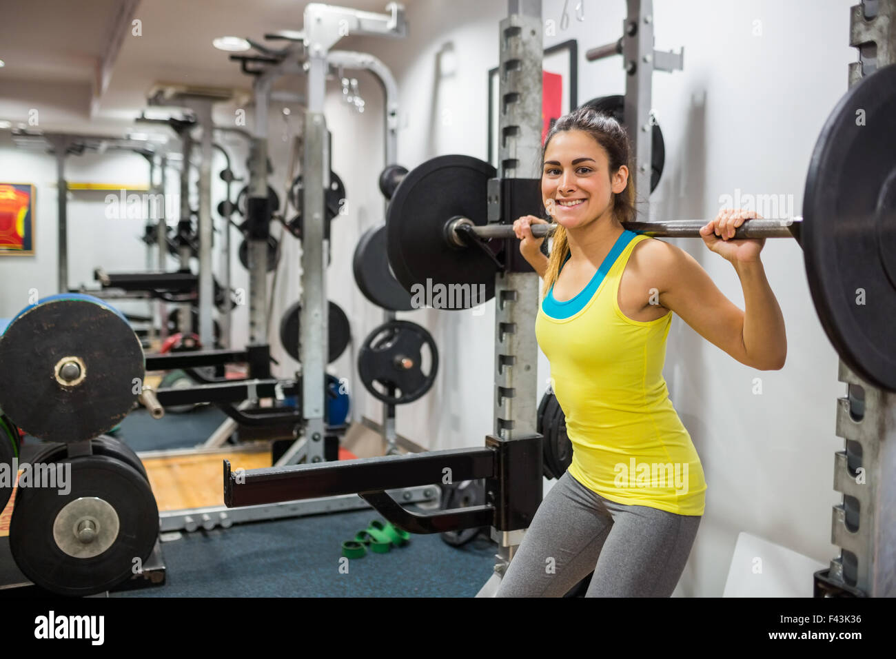 Determined woman lifting a barbell Stock Photo