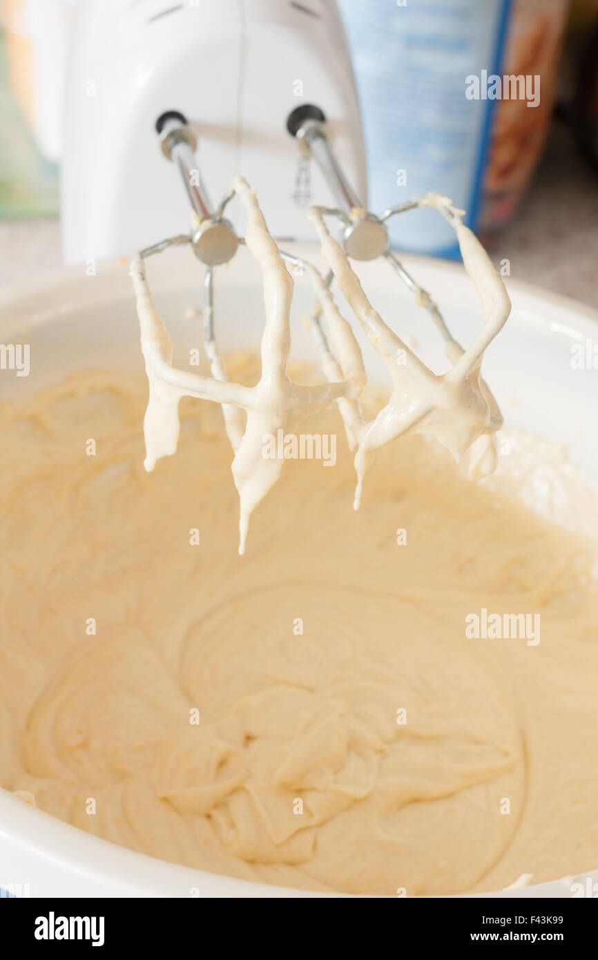 Mixing or blending cake batter with an electric whisk Stock Photo