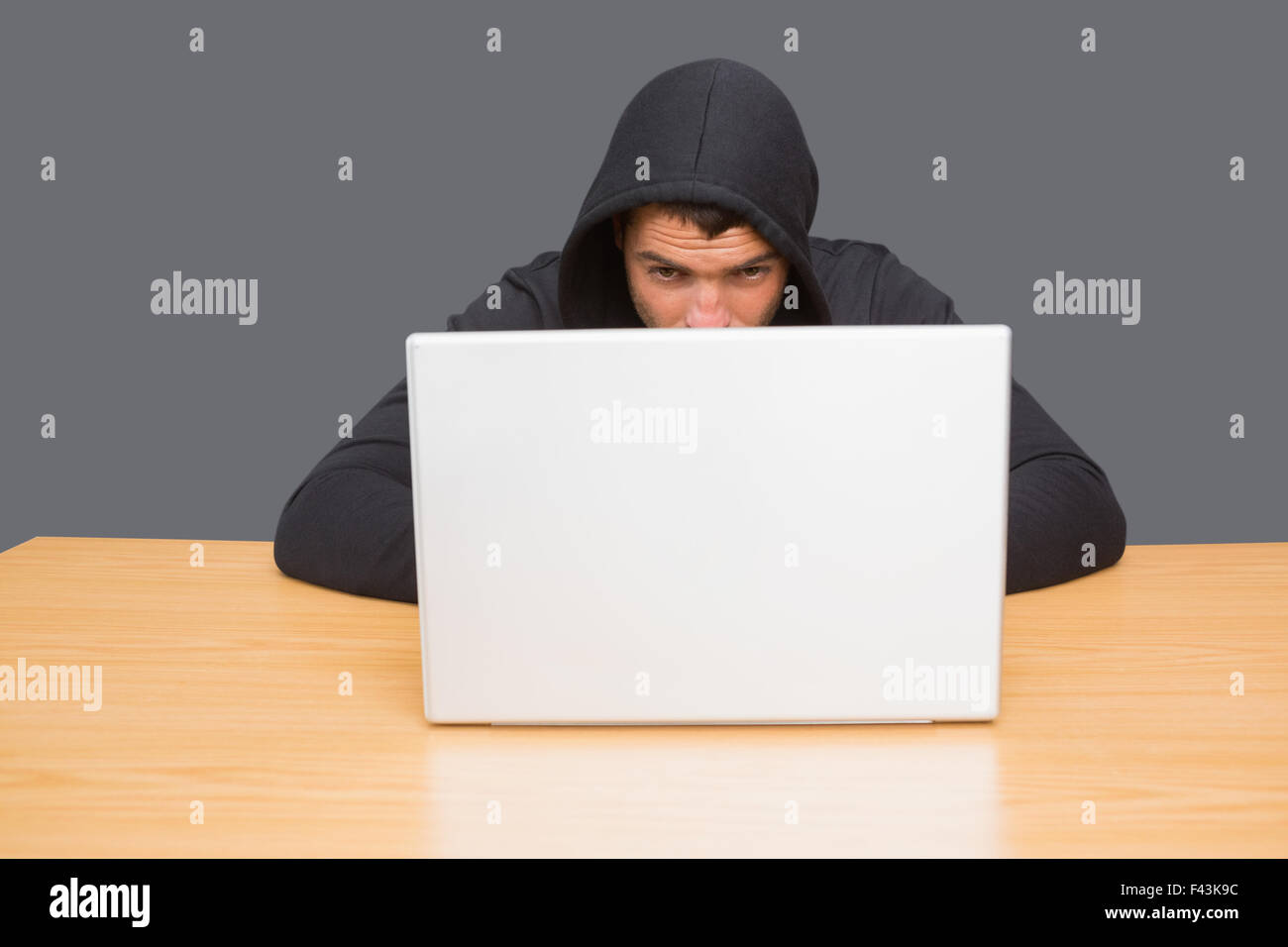 Hacker using laptop to steal identity Stock Photo