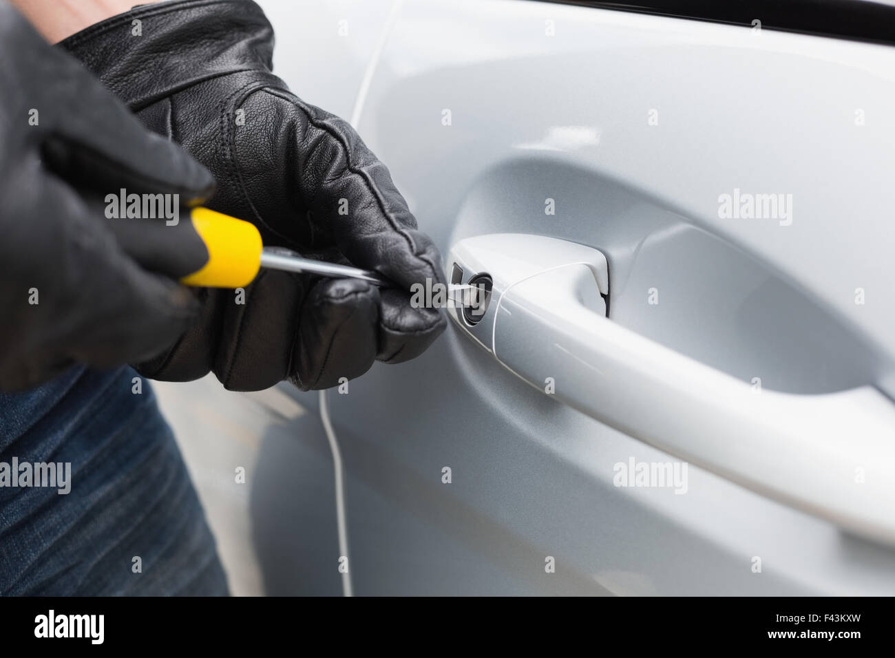 Thief breaking into a car Stock Photo Alamy