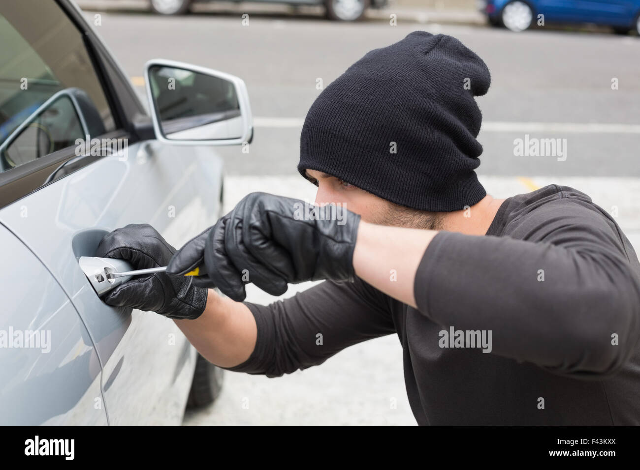 Thief breaking into car with screwdriver Stock Photo Alamy