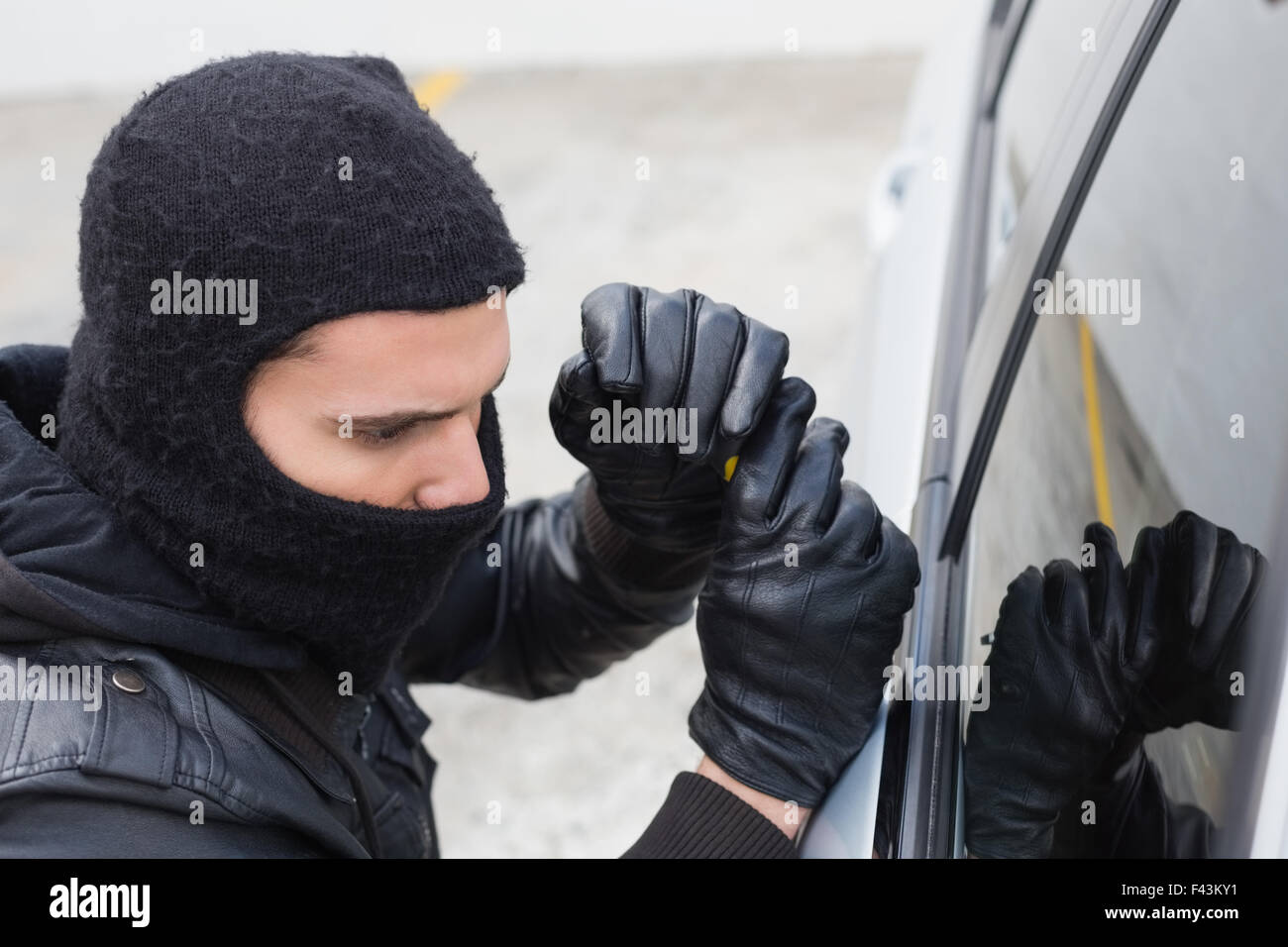 Thief breaking into a car Stock Photo Alamy