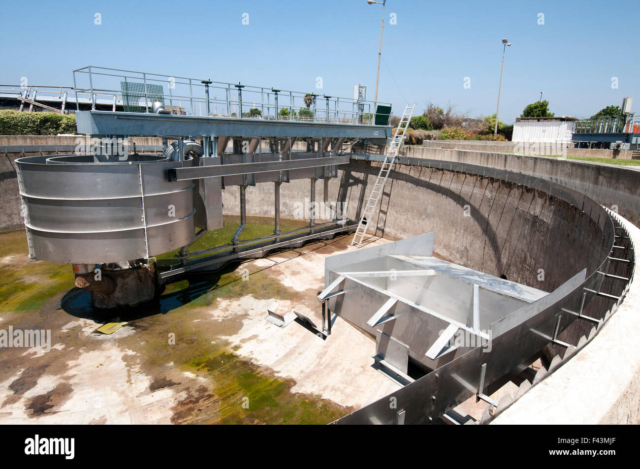 Empty Primary sedimentation pool at a Sewerage treatment facility. The treated water is then used for irrigation and agricultura Stock Photo