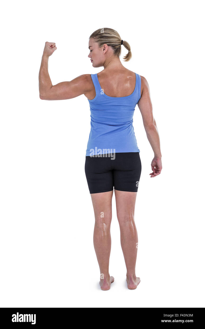 Rear view muscular woman flexing hi-res stock photography and