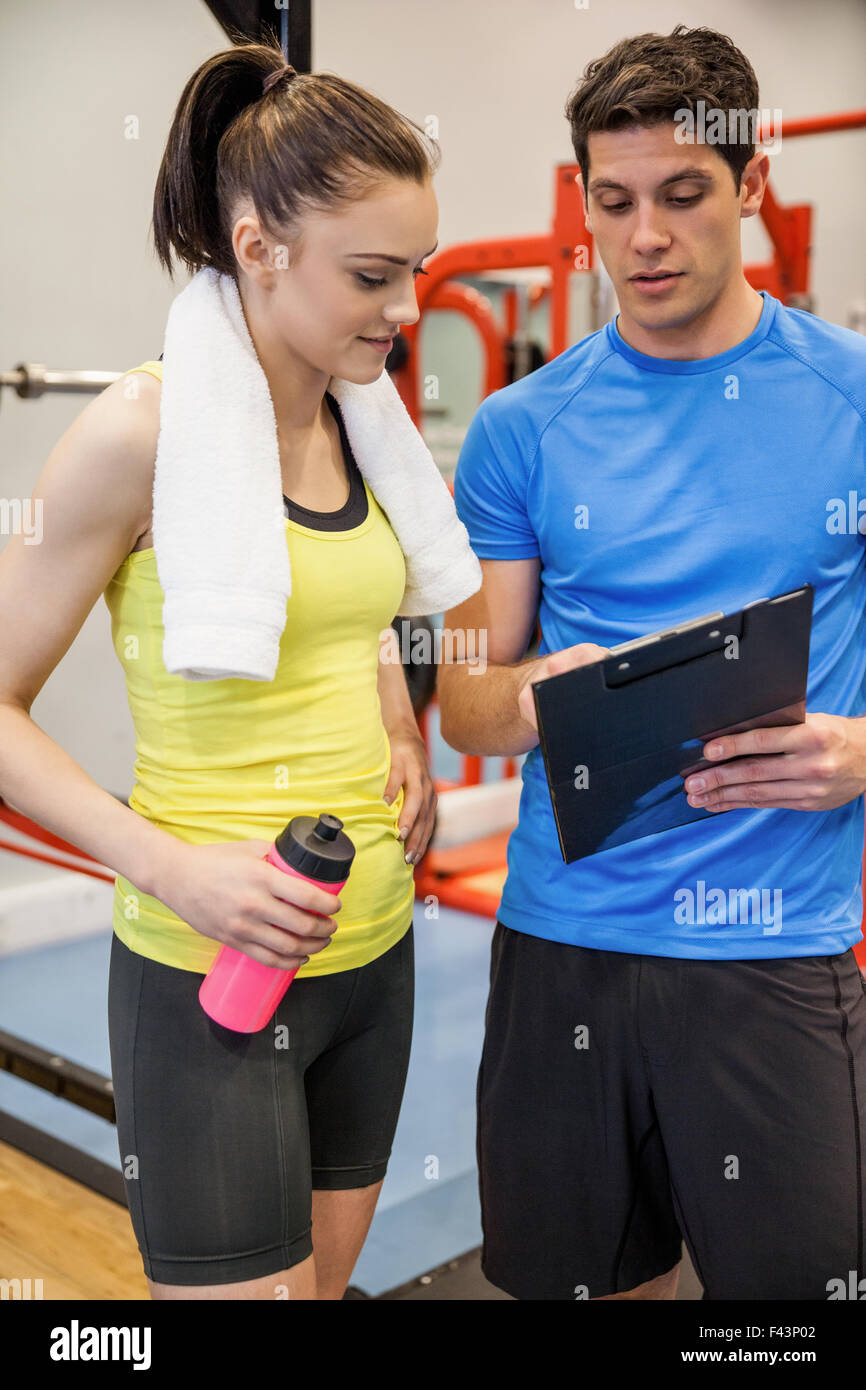 Trainer and woman discussing workout plan Stock Photo - Alamy