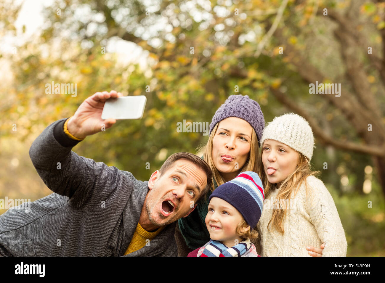 Smiling young family taking selfies Stock Photo