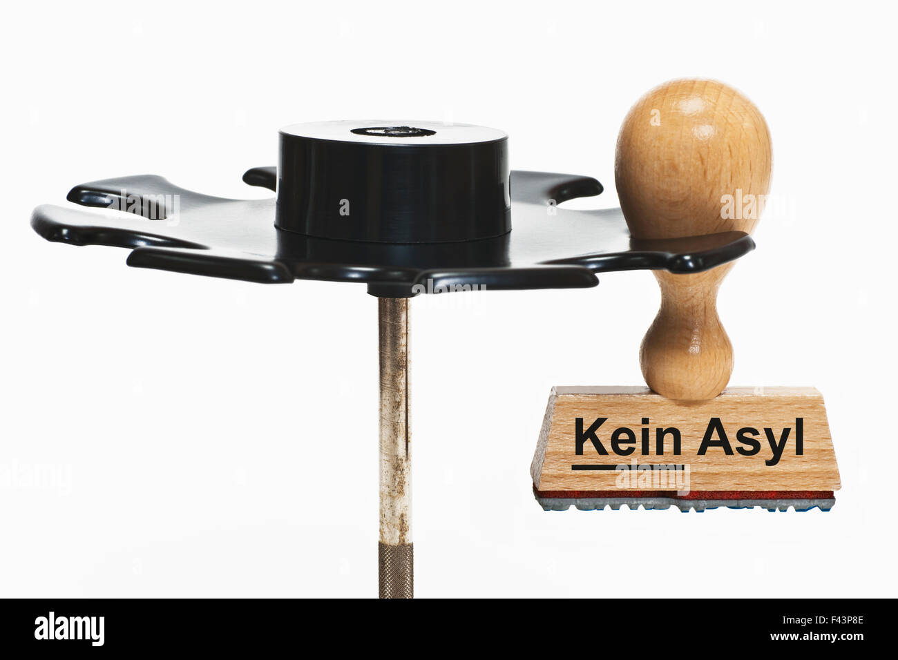 a stamp with the German inscription Kein Asyl (No Asylum) hangs in a stamp rack Stock Photo