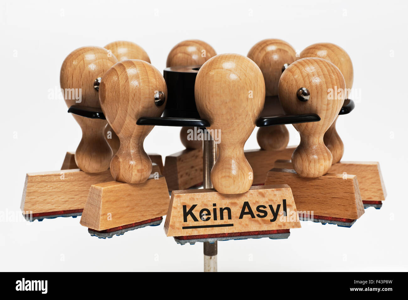 a stamp with the German inscription Kein Asyl (No Asylum) hangs in a stamp rack Stock Photo
