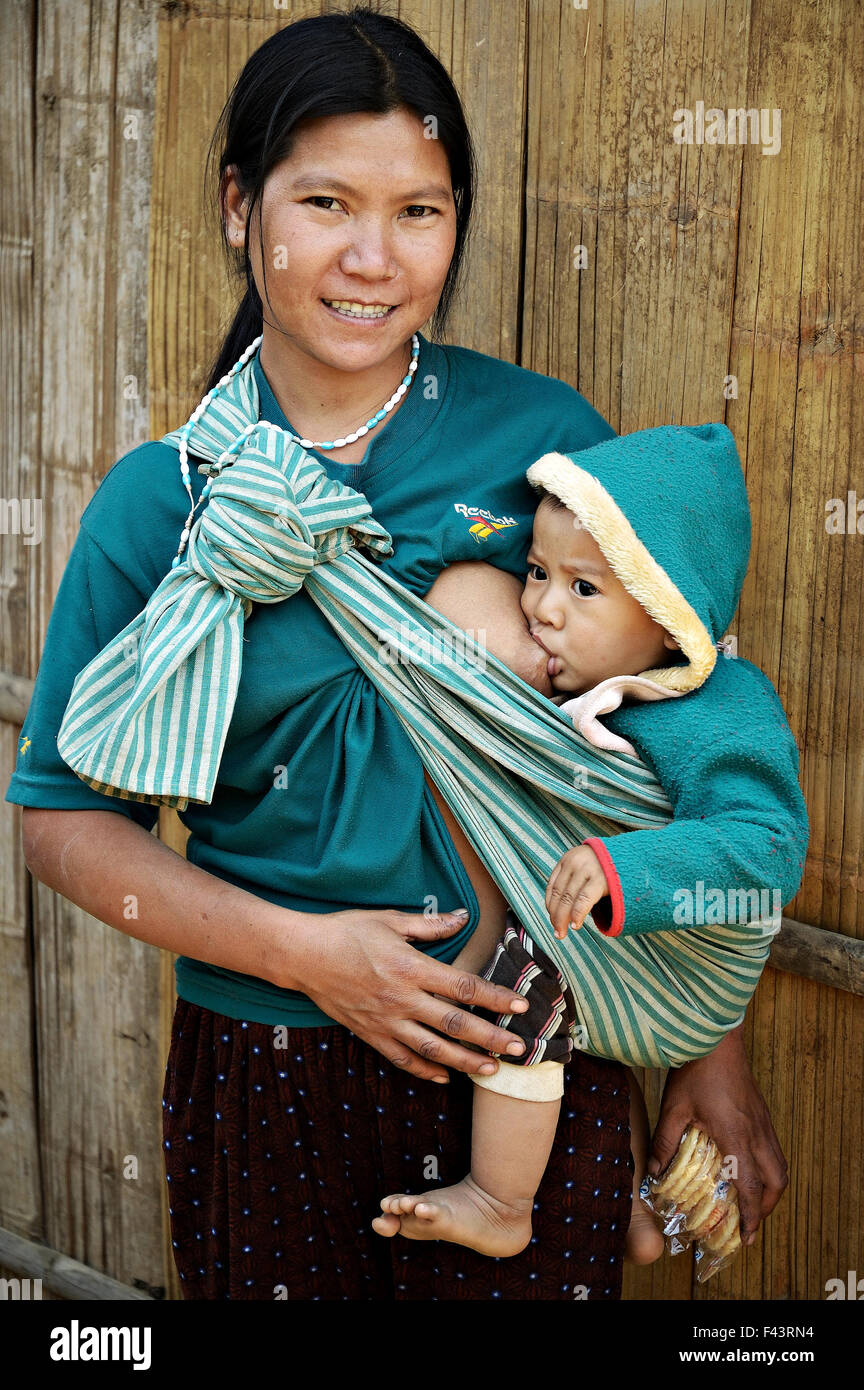 Young mom breastfeeding her baby in an Akha village around Kengtung  (Kyaingtong), Shan State, Myanmar Stock Photo - Alamy